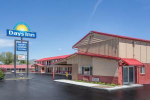 a view of a days inn sign in a parking lot at Days Inn by Wyndham Elko in Elko