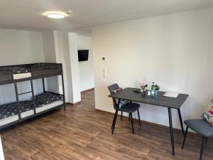 a room with a table and a bunk bed at R&B pension in Ichenhausen