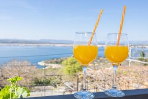 two glasses of orange juice sitting on a table at Casa Vita in Dramalj