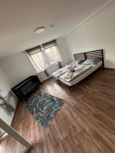 a bedroom with a bed and a wooden floor at R&B pension in Ichenhausen