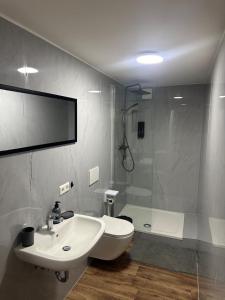 a bathroom with a sink and a shower at R&B pension in Ichenhausen +13 photos