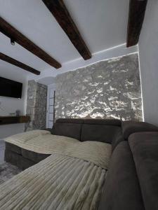 a bedroom with a bed and a couch at Sunrise Skadar lake in Braćeni