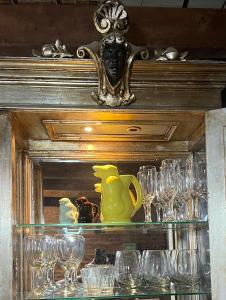 a shelf with glasses and a pitcher on it at Loft con patio frente a Mercado San Telmo, 2 baños in Buenos Aires