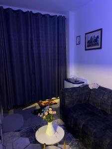 a living room with a couch and a table with flowers at Royalty homes in Kiambu