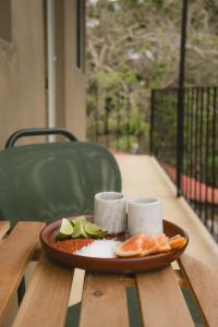 a plate of food sitting on a wooden table at Ánimo Perro in Sayulita