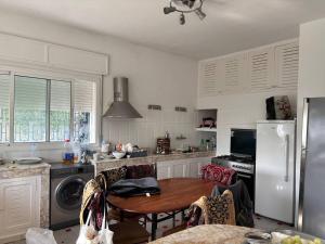 a kitchen with a table and a refrigerator at Villa Meryem in Tangier
