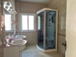 a bathroom with two sinks and a shower at Villa Meryem in Tangier