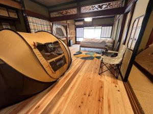 a room with a bed in the middle of a room at HAPPY MAGIC guesthouse in Tateyama