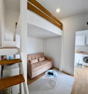 a living room with a loft bed and a couch at Yellow Guesthouse in Faro