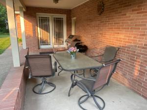 a patio with two chairs and a table with flowers on it at Private king suite in Dubuque