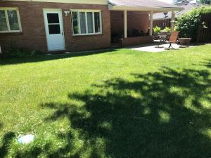 a yard with a house and a lawn with a table and chairs at Private king suite in Dubuque