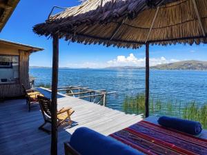 a wooden deck with a view of the water at Uros Killa Lodge in Puno