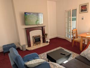 a living room with a tv above a fireplace at Affleck Street in Gateshead
