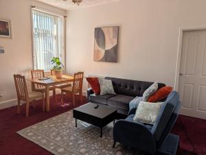 a living room with a couch and a table at Affleck Street in Gateshead