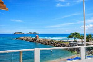 a view of the ocean from the balcony of a resort at Suites Quebra Mar in Rio de Janeiro