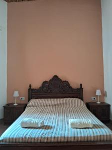 a bedroom with a bed with two shoes on it at Inti Raymi in Maimará