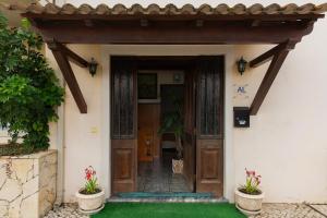 an entrance to a house with a wooden door at Casa da Lala - Alojamento a 4km de Fátima in Fontainhas