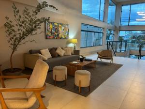 a living room with a couch and a table at Flats Beira Mar in Caraguatatuba