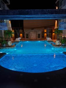 a large swimming pool in a hotel at night at Arisara place in Koh Samui