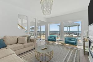 a living room with a couch and a table and chairs at Oceanfront Luxury Private Steps to Beach New in Oak Island