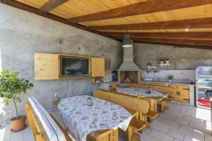 a dining room with two tables and a kitchen at Apartment in Hreljin 39448 in Hreljin