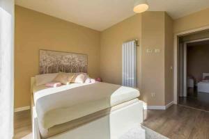 a bedroom with a large white bed with pink pillows at Apartment in Hreljin 39448 in Hreljin +28 photos