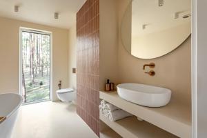 a bathroom with a sink and a mirror at Forest Hub Popowo in Huta Podgórna +31 photos