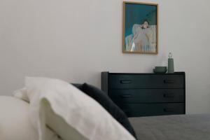 a bedroom with a bed and a dresser with a picture at Casa Sabina Expiatorio in Guadalajara