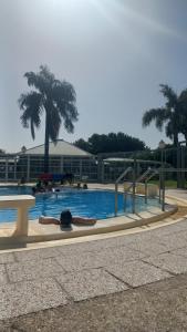 a swimming pool with people laying in the water at AltoRojo in Villa Elisa +15 photos