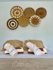 a shelf with towels and hats on a wall at Alma Nusa Penida in Nusa Penida +68 photos