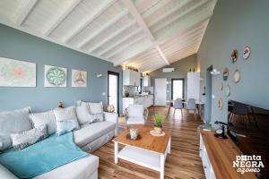a living room with a couch and a table at Beer House by PontaNegraAzores in Altares