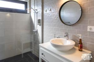 a bathroom with a sink and a mirror at Beer House by PontaNegraAzores in Altares +27 photos