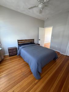 a bedroom with a bed and a ceiling fan at Providence Cozy Stays in Providence +2 photos