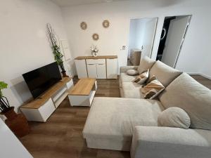 a living room with a couch and a flat screen tv at Cosy home in Saint Martin