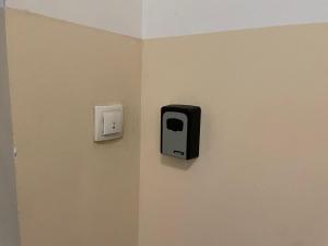 a wall with a soap dispenser on a wall at SkyBreak Apartment in Ledine
