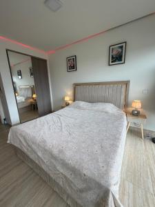 a bedroom with a large bed and a mirror at Ayla golf in Aqaba
