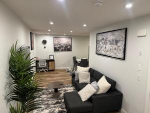 a living room with a couch and a table at 5 Star Suite with Free Parking and Easy Access to Downtown in Calgary