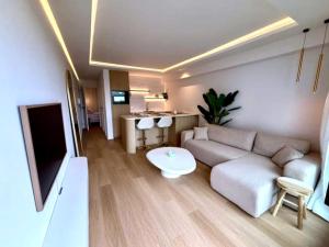 a living room with a couch and a table at Luxury apartment with sea view in Westende-Bad +2 photos
