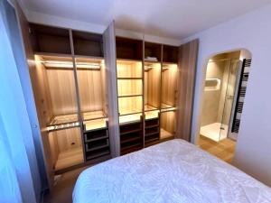 a bedroom with a bed and some wooden cabinets at Luxury apartment with sea view in Westende-Bad