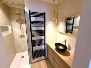 a bathroom with a black sink and a mirror at Luxury apartment with sea view in Westende-Bad