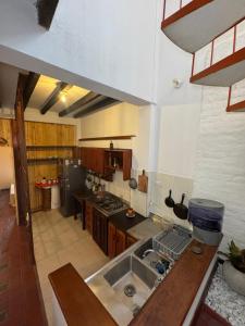a kitchen with a sink and a counter top at Hospedaje Casa Renasiente - Guest house in Cali