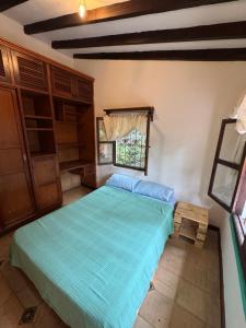 a bedroom with a large green bed in a room at Hospedaje Casa Renasiente - Guest house in Cali