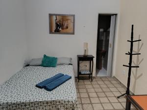 a bedroom with a bed with a blue pillow on it at Suites Dupla beira mar Carapibus in Conde +7 photos