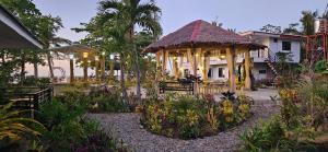 a house with a gazebo in a garden at Vhora Inn Sibuyan in Magdiwang