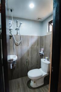 a bathroom with a toilet and a sink at Hidden Garden Villa in El Nido +37 photos