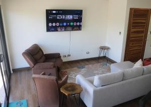 a living room with a couch and two chairs at Villa Nomad in Naranjito