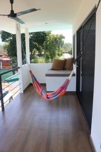 a hammock in the living room of a house at Villa Nomad in Naranjito