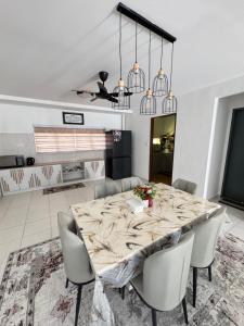 a dining room with a large marble table and chairs at KY Stay D'Serkam in Serkam