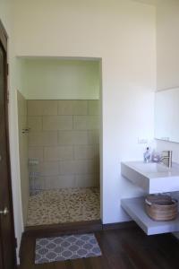 a bathroom with a sink and a toilet and a shower at Villa Nomad in Naranjito +4 photos