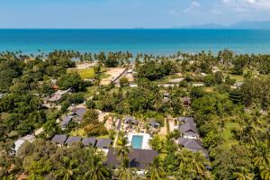 an aerial view of a resort with the ocean in the background at Moorea Boutique Resort Samui in Ban Tai
